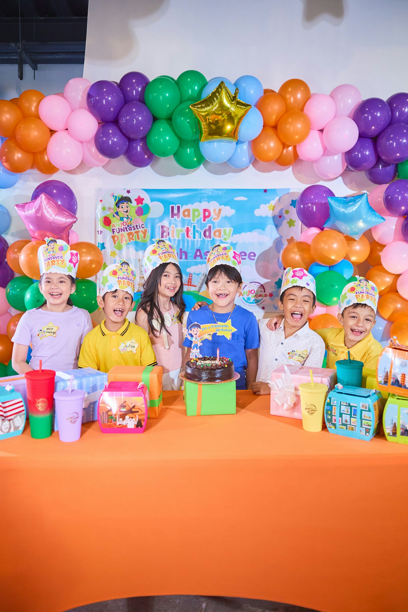 Children celebrating around a birthday cake