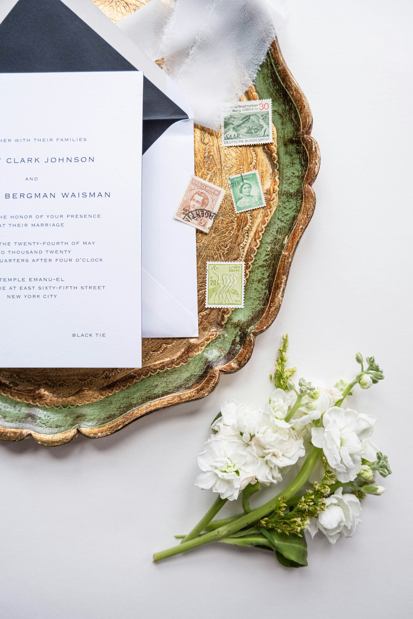Printed wedding invitations arranged with flowers